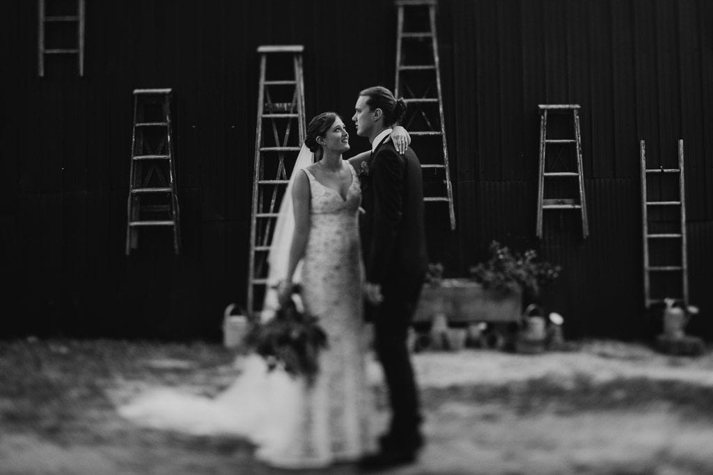 Black and white wedding photograph of Bride, Alex, and groom, Tom at their wedding at The Woods Farm on the south coast