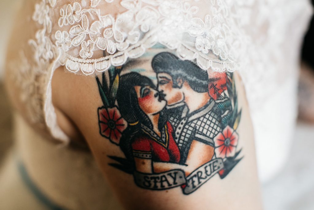 Bride's tattoo of couple kissing with a ribbon saying 'stay true', taken at her Jaspers Berry wedding