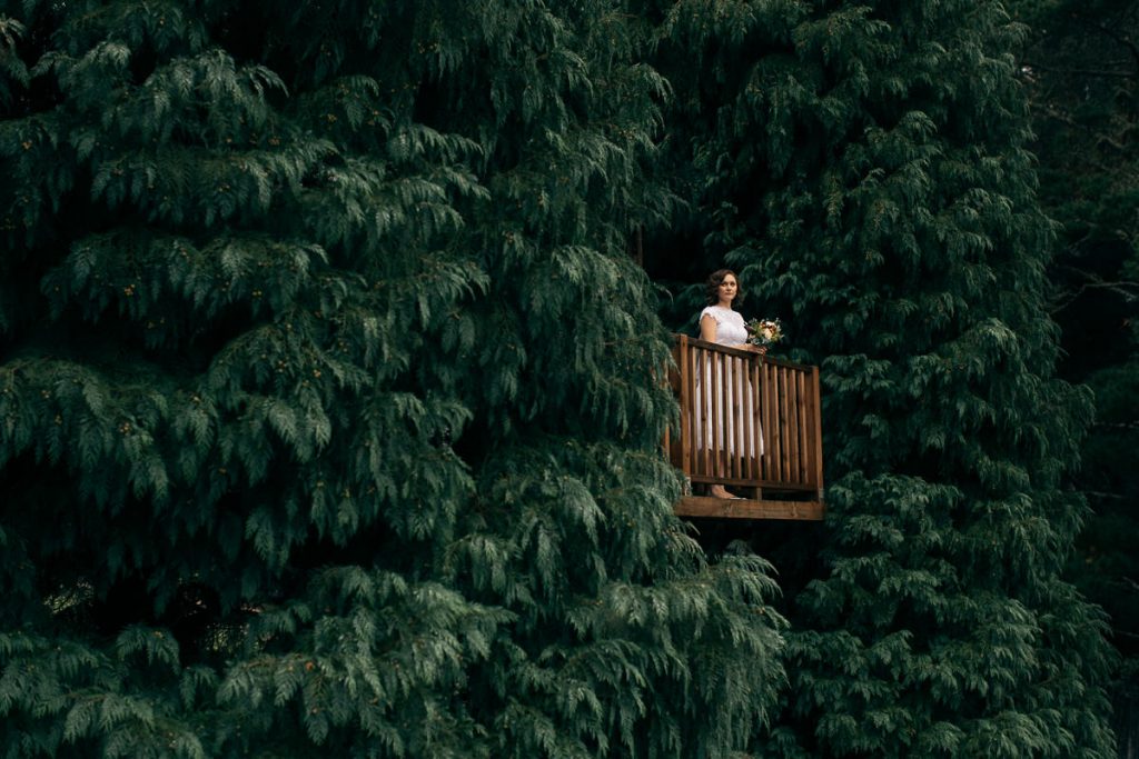 Bilpin Wedding Photographer; Anita stands on a platform high in the trees at her wedding in Bilpin