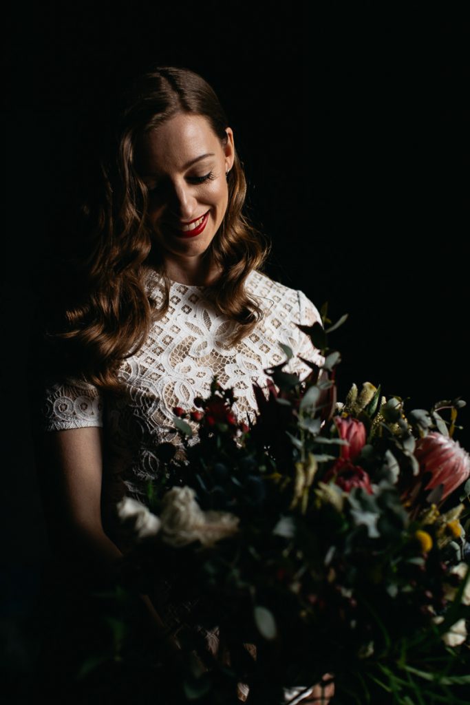 Wedding Photography Southern Highlands; Bowral; Bride looking at her bouquet happily