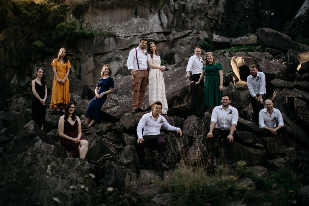 Bridal party sit around the rocks for photographs at a Bowral Wedding; Southern Highlands Wedding Photography
