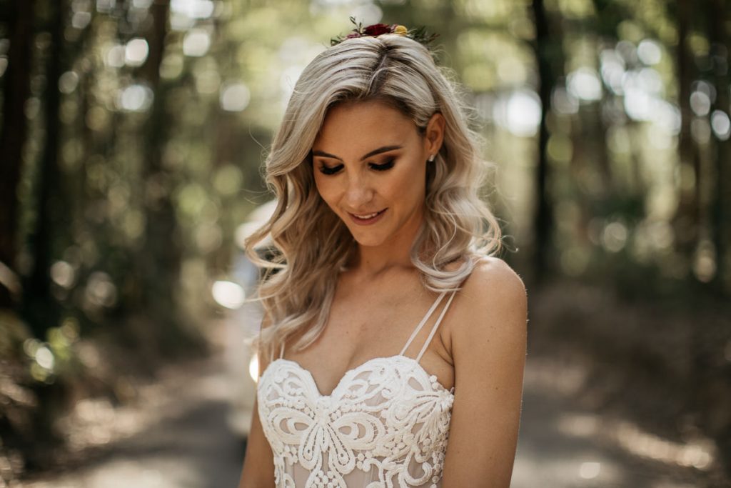 Wedding portrait of a bride looking down smiling in the fiorest at Bundanon in the South Coast