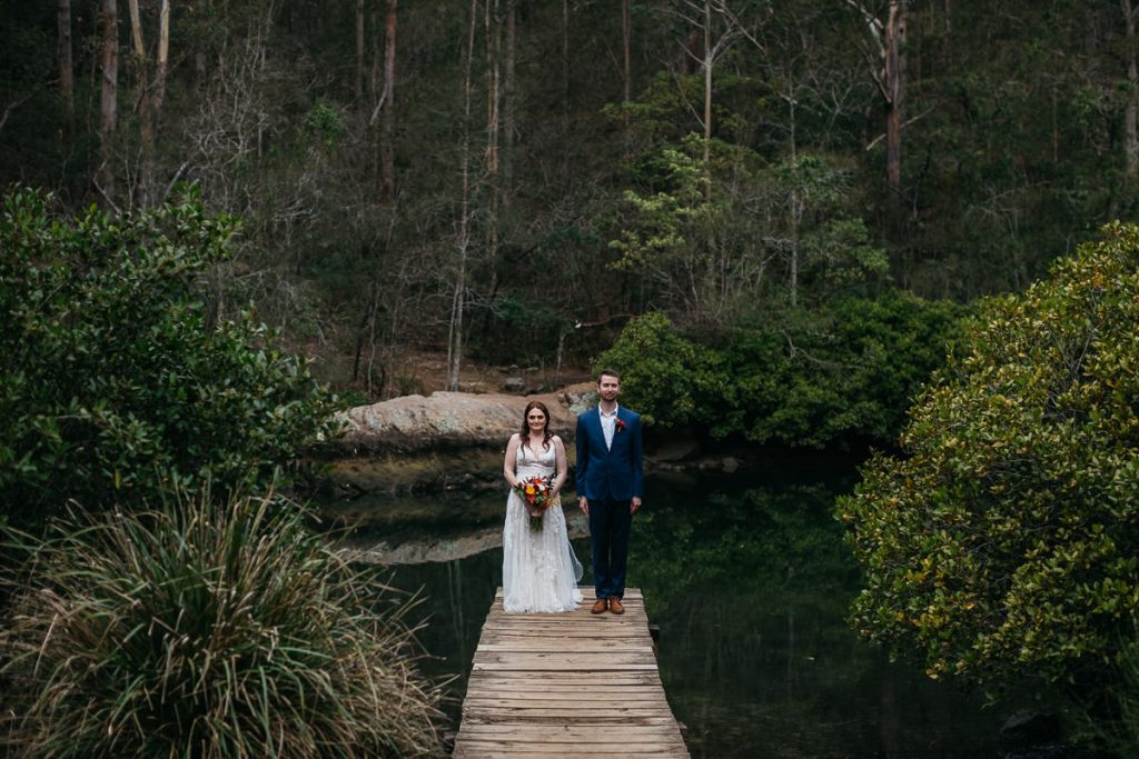 Bride and Groom standing on the jetty at their Butter Factory Wedding ; wedding photographer south coast