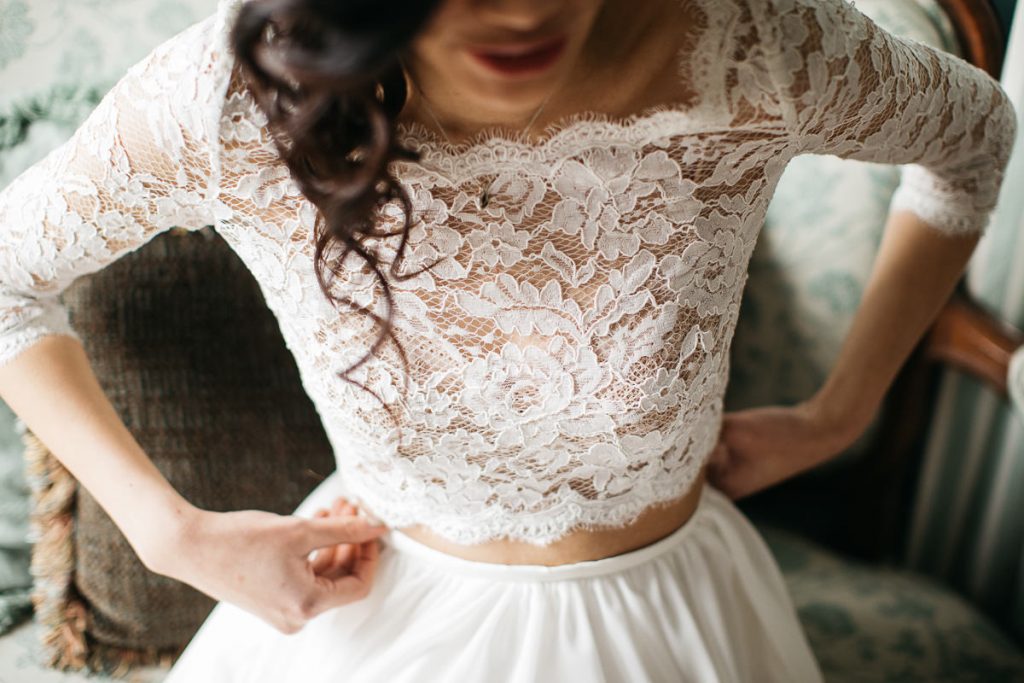 Protrait of the lacy top of a ivory wedding gown at a Growwild Wildflower Farm wedding