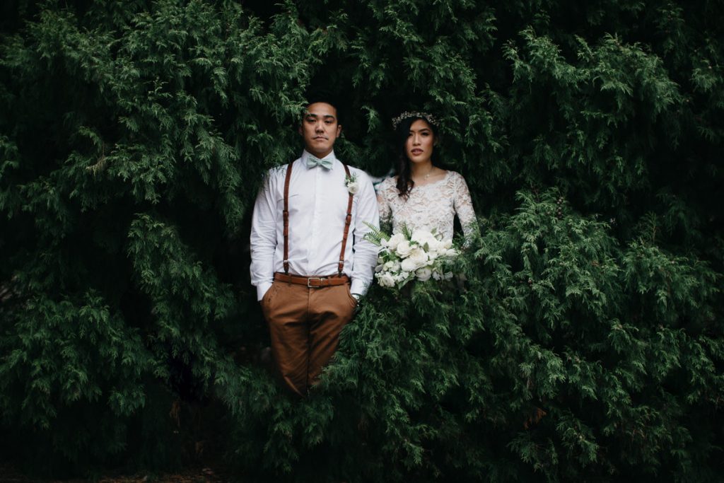 Photograph of bridal couple surraunded by green bushes at Growwild Wildflower Farm