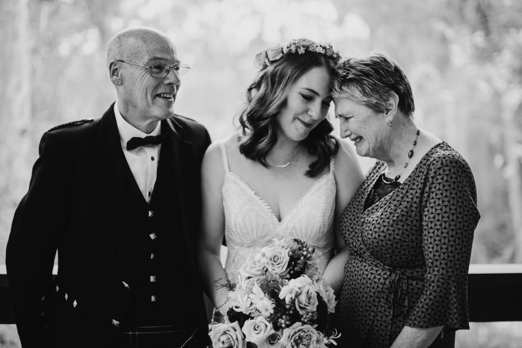 Black and white photograph of a bride having a touching moment with her parents; kangaroo valley bush retreat wedding photography; south coast