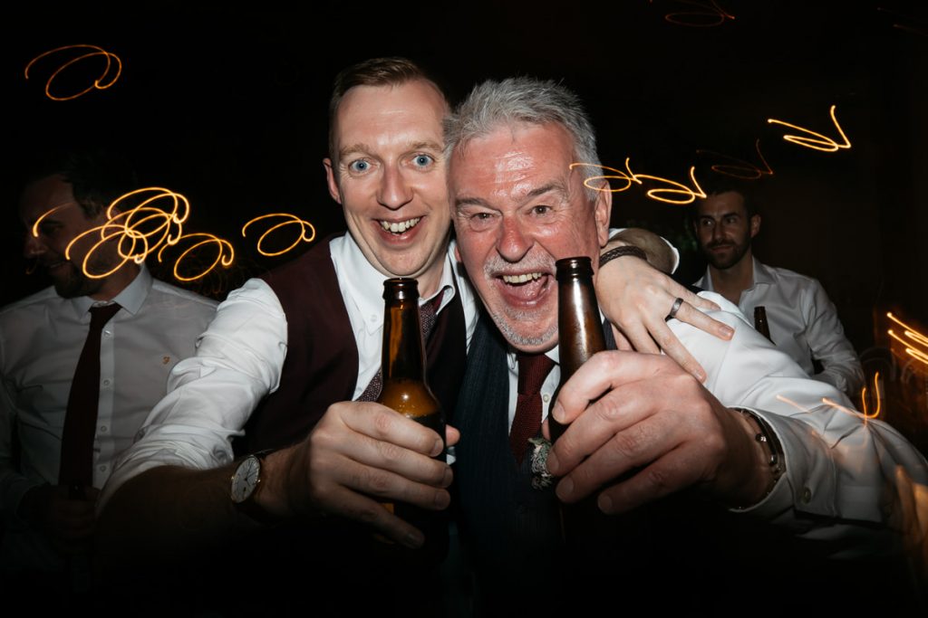 Guests say cheers with their beer to the wedding photographer; Melross - Kangaroo Valley - South Coast