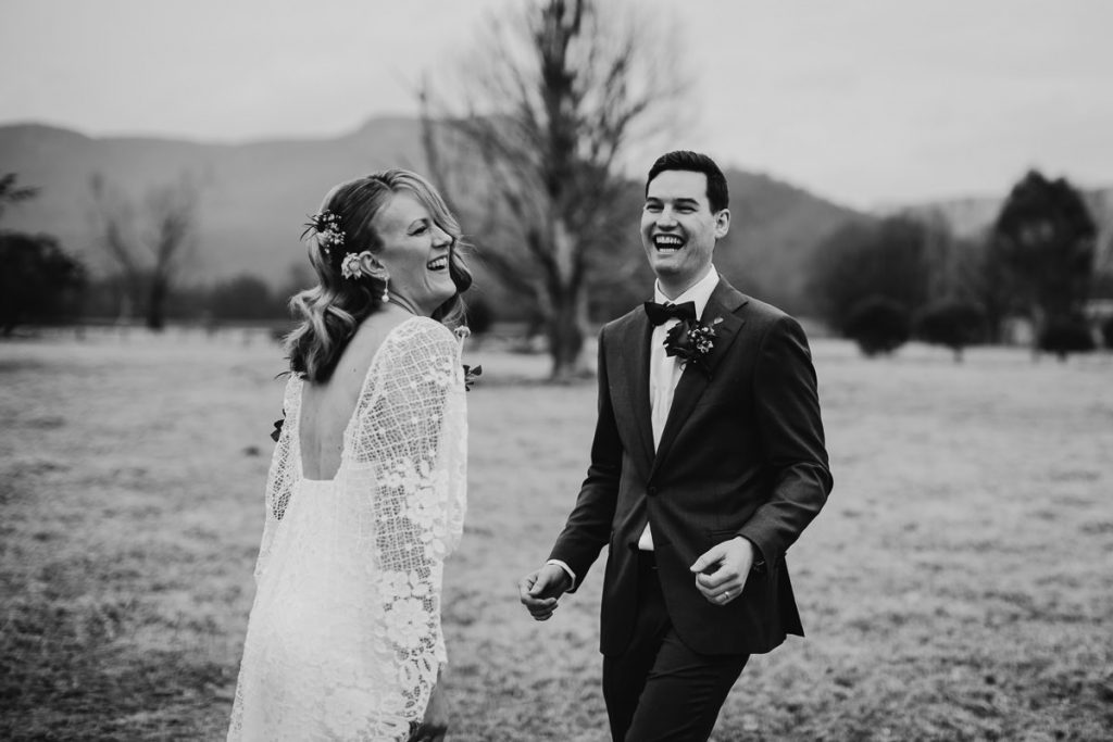 Black and white photo of bride and groom laughing outdoors at melross in the Kangaroo Valley; Wedding photographer South Coast