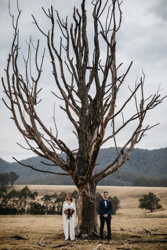 Kangaroo Valley Wedding Photography: Kat + Brendon pose infront of a leafless tree at their wedding in Melross, Kangaroo Valley