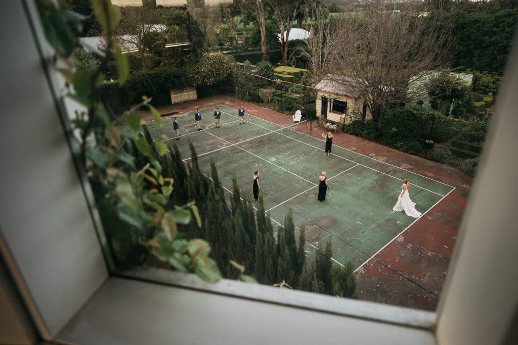 Aerial photograph of Bridal party playing tennis at a Merribee Wedding on the South Coast