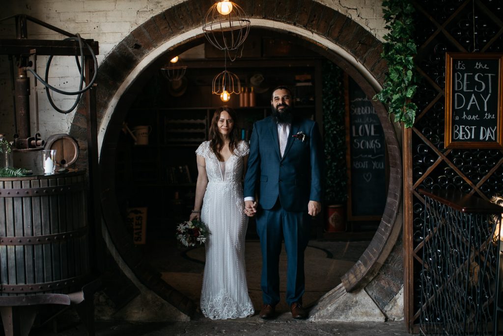 Wedding photo of a bridal couple standing in a circular doorway of their wedding venue in Bowral in the Southern Highlands