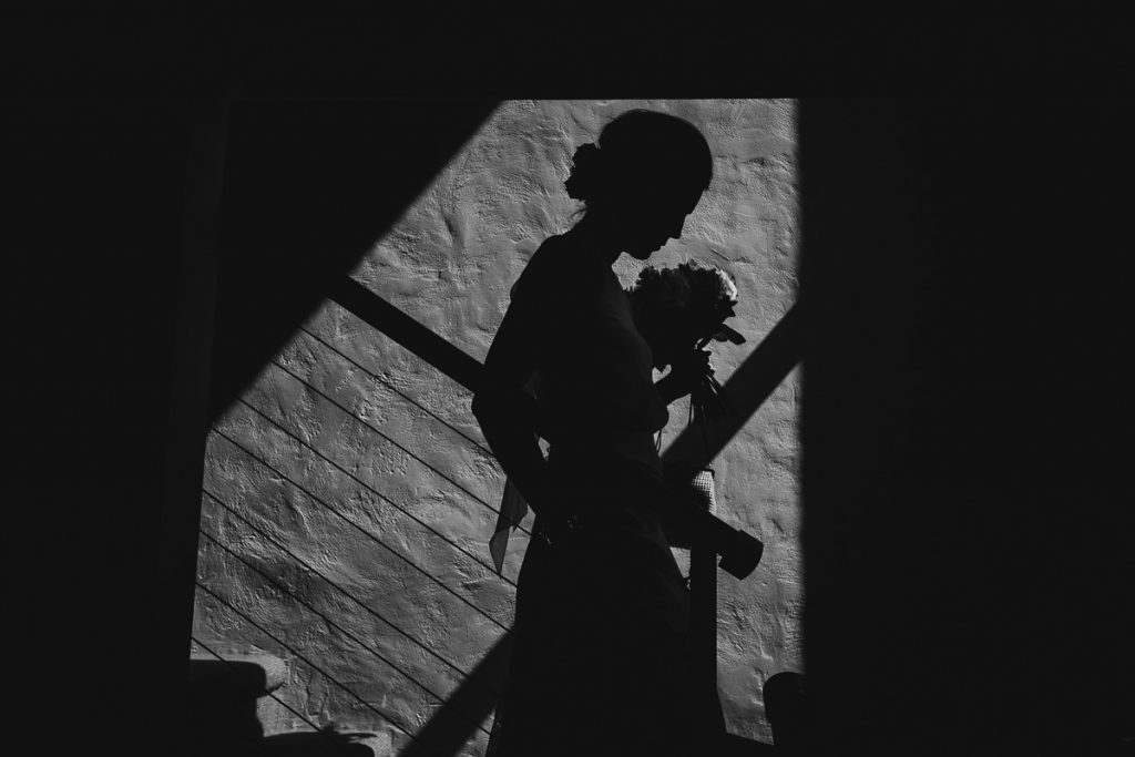 Creative balck and white silhouette portrait of bride walking down the stairs; Wedding photography South Coast