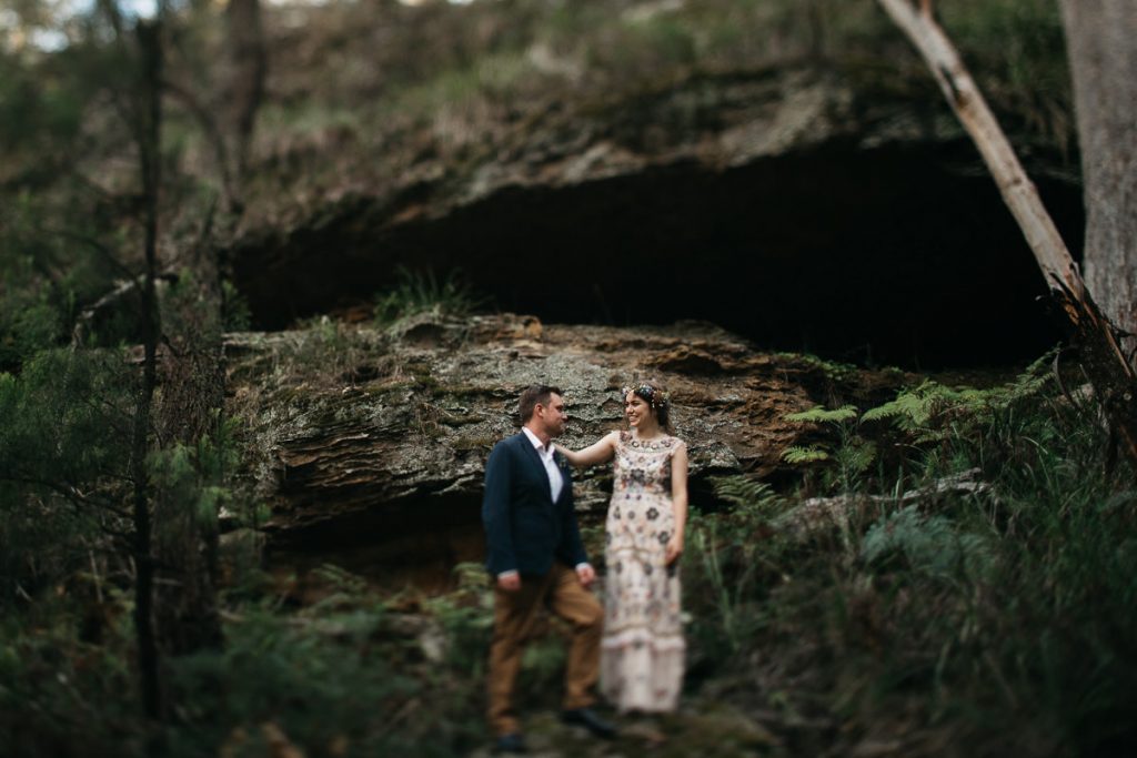 Bride and groom pose in front of huge rocks at their Bowral Wedding; Southern Highlands Wedding Photographer