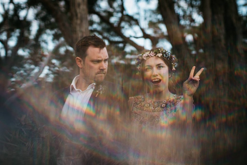 Creative wedding photography of bride and groom catching the light, making rainbows at their southern highlands wedding
