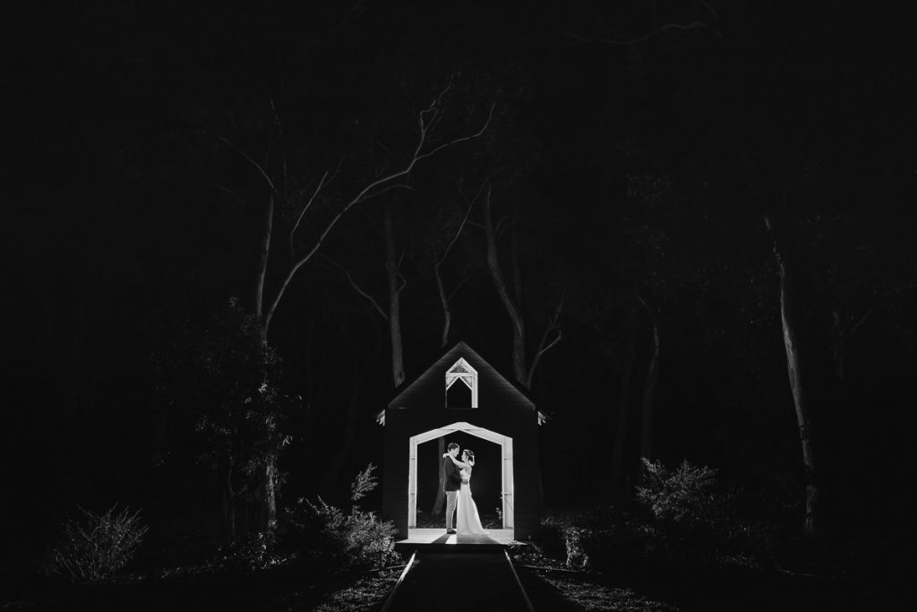 Black and white nighttime photograph of bride and groom in a mini house-shaped gazebo at Wildwood; kangaroo Valley Wedding Photographer South Coast