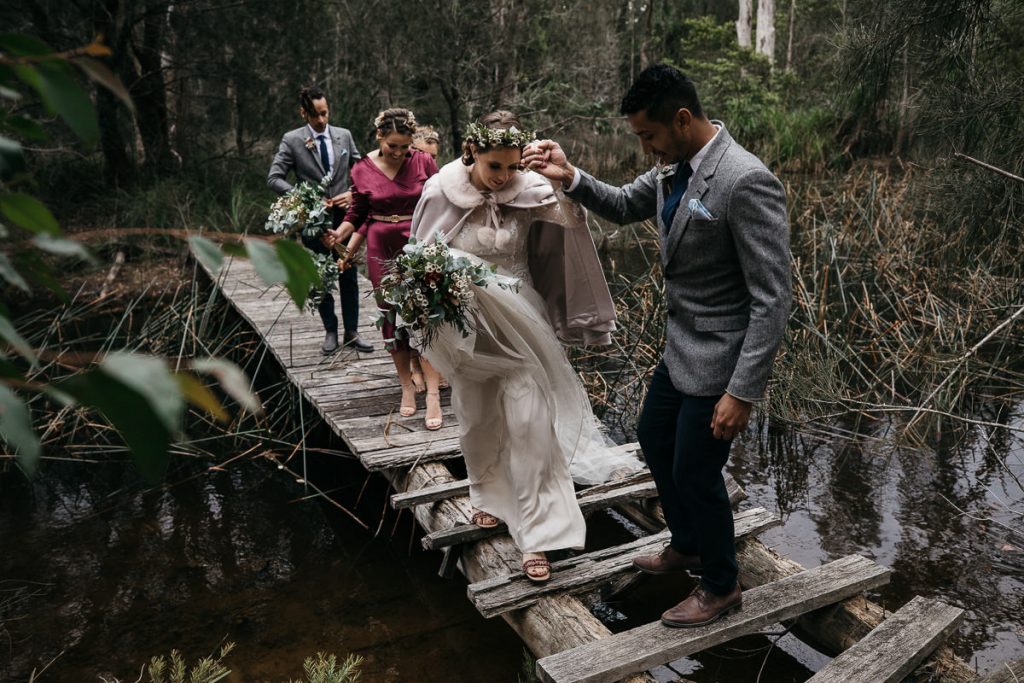 bridal couple traverse a rickety jetty at their Worrowing wedding; South Coast Wedding photography